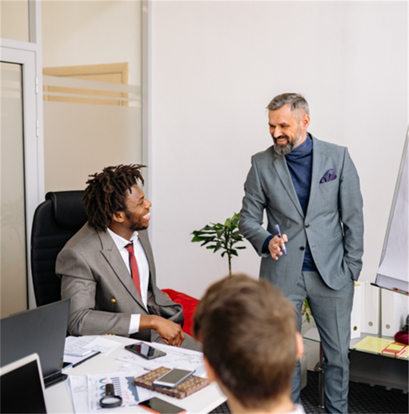 Professionals at an office meeting for executive health and wellness.